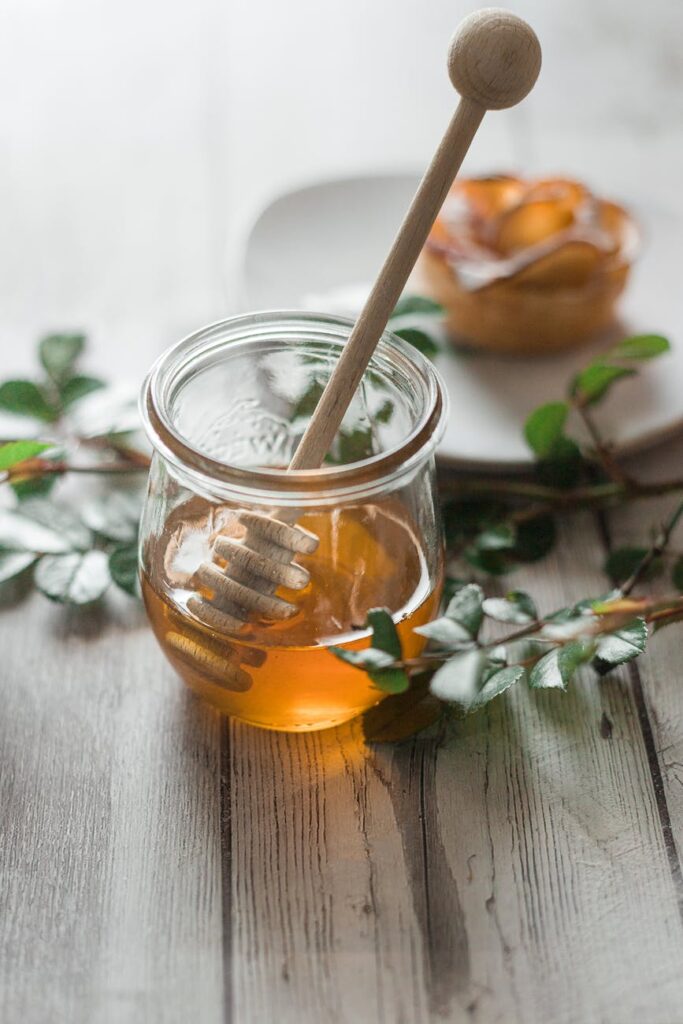 clear glass jar with honey